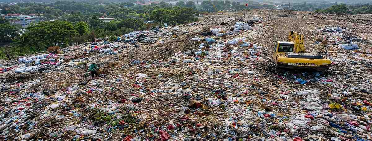 Plastic waste covering a landfill highlighting the environmental impact of plastic pollution and the Say No to Plastic awareness campaign by Indbharat Global Foundation